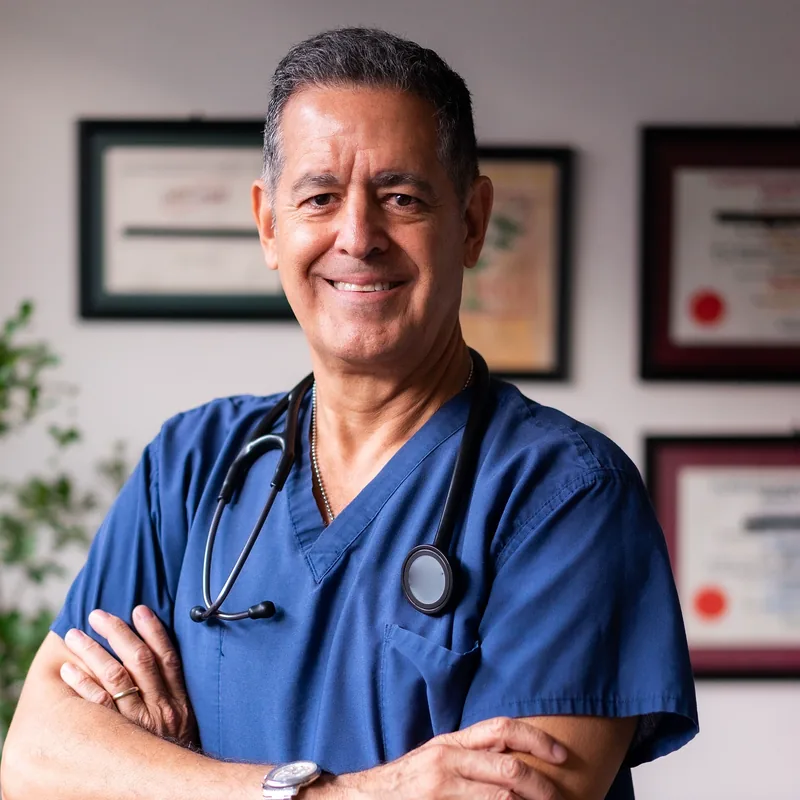 A clinician wearing blue scrubs and a stethoscope